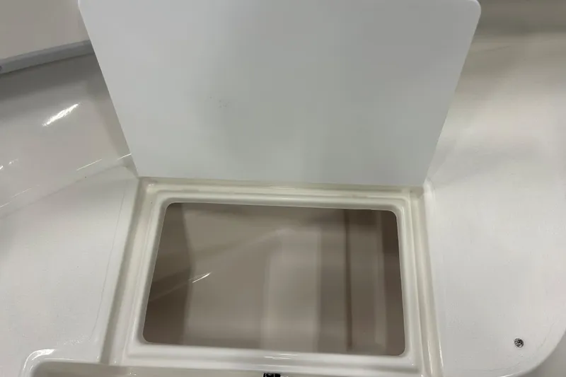 Slide: The Image of 2026 Maycraft 238CC boat storage compartment with open lid, showcasing interior space. - 18