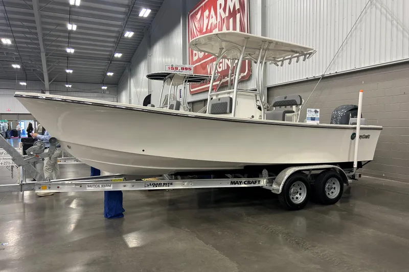 Slide: The Image of 2026 Maycraft 238CC boat displayed indoors on a trailer. - 2