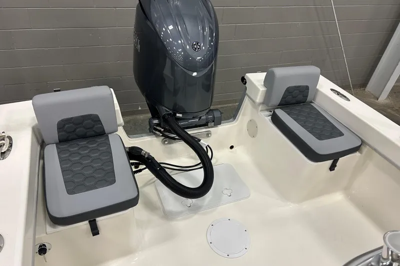 Slide: The Image of 2026 Maycraft 238CC boat interior with cushioned seating and motor. - 22