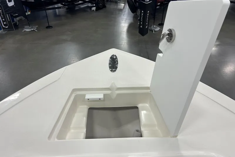 Slide: The Image of 2026 Maycraft 238CC boat with open storage compartment in showroom. - 25