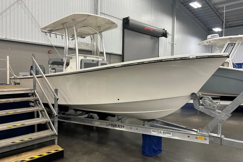 Slide: The Image of 2026 Maycraft 238CC boat on trailer in indoor showroom. - 3