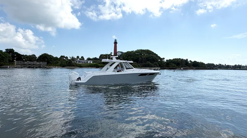 Slide: The Image of Intrepid 35 VALOR 2026 on calm water near a lighthouse. - 0