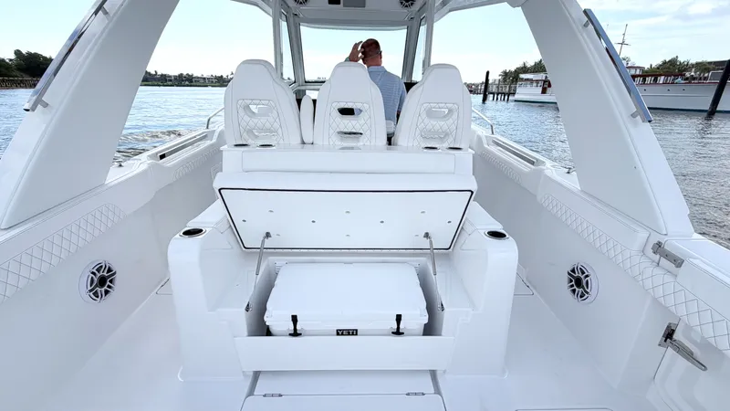 Slide: The Image of Intrepid 35 VALOR 2026: Spacious cockpit with seating and cooler, on calm water. - 15