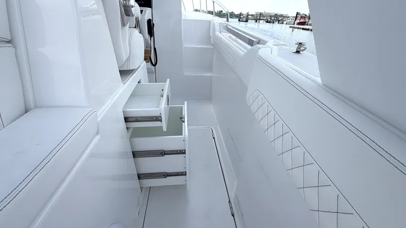 Slide: The Image of Intrepid 35 VALOR 2026: Sleek white cockpit with open drawers and quilted seating. - 25