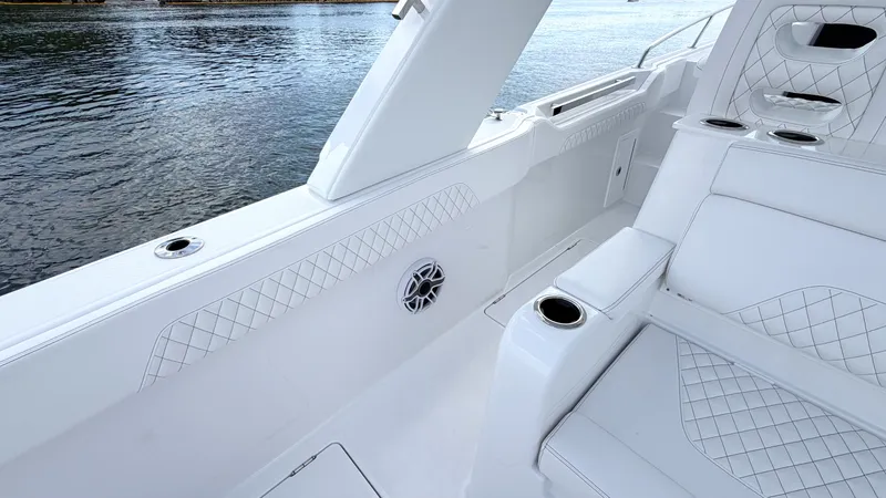 Slide: The Image of Intrepid 35 VALOR 2026: Luxurious white seating with quilted pattern, on calm water. - 26