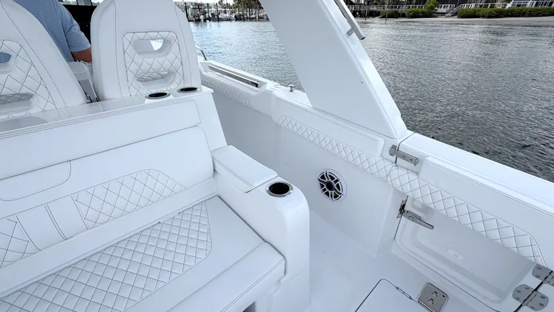 Slide: The Image of Intrepid 35 VALOR 2026: Luxurious white seating with quilted pattern, on calm water. - 27