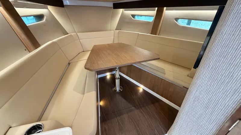 Slide: The Image of Interior of the 2026 Intrepid 35 VALOR with elegant seating area and wooden table. - 36