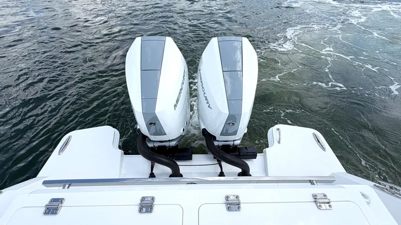 Slide: The Image of Two powerful outboard engines on a boat in choppy water. - 38