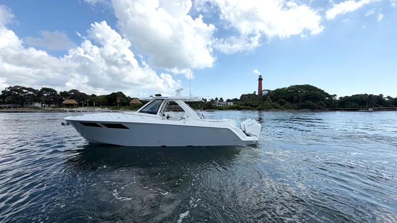 Slide: The Image of Intrepid 35 VALOR 2026 on calm water with a lighthouse and wooded shoreline in the background. - 4