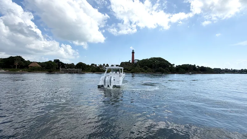 Slide: The Image of An Intrepid 35 VALOR boat from 2026 on calm water with a lighthouse in the background. - 6