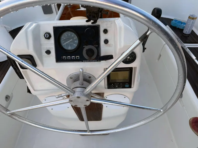 Slide: The Image of Steering wheel and control panel of a 1990 Beneteau 370 sailboat. - 10