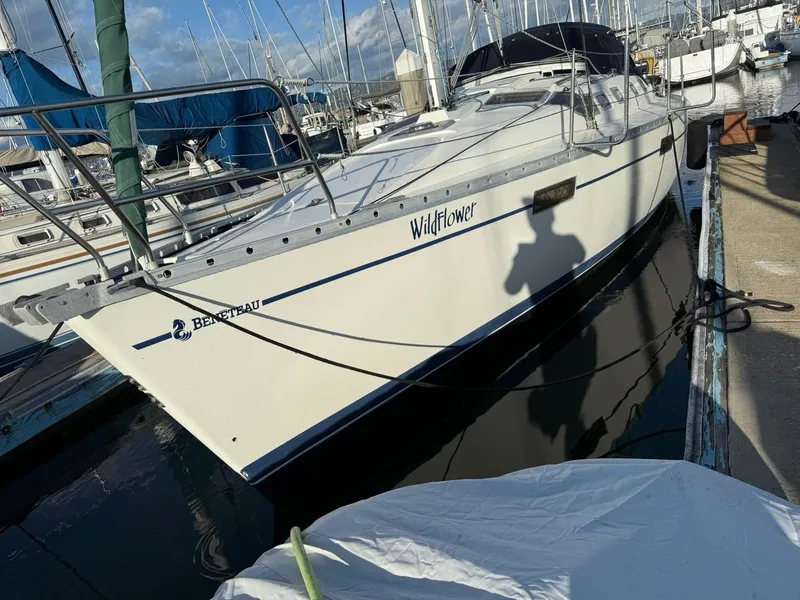 Slide: The Image of 1990 Beneteau 370 sailboat named "Wildflower" docked at a marina. - 3
