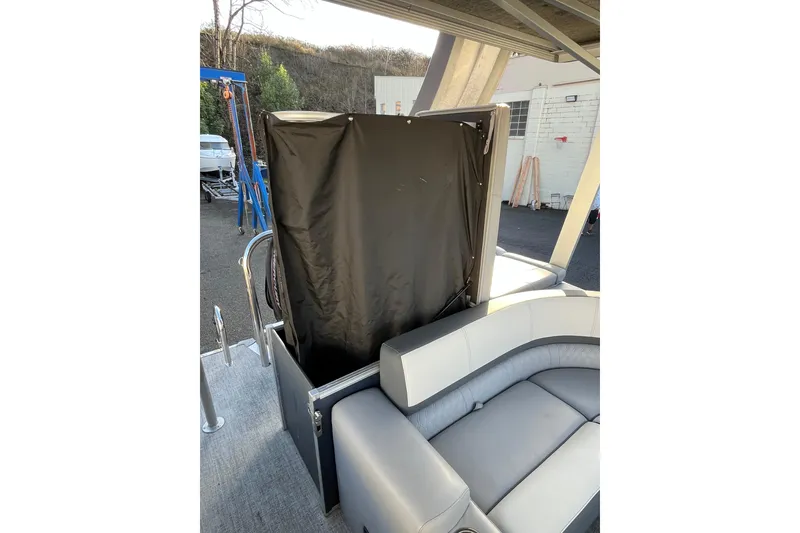 Slide: The Image of 2025 Tahoe Pontoon Cascade Cruise Funship interior with seating and privacy curtain. - 16