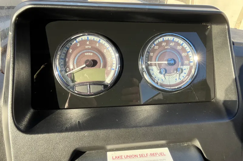 Slide: The Image of Dashboard of 2025 Tahoe Pontoon Cascade Cruise Funship with RPM and MPH gauges. - 17