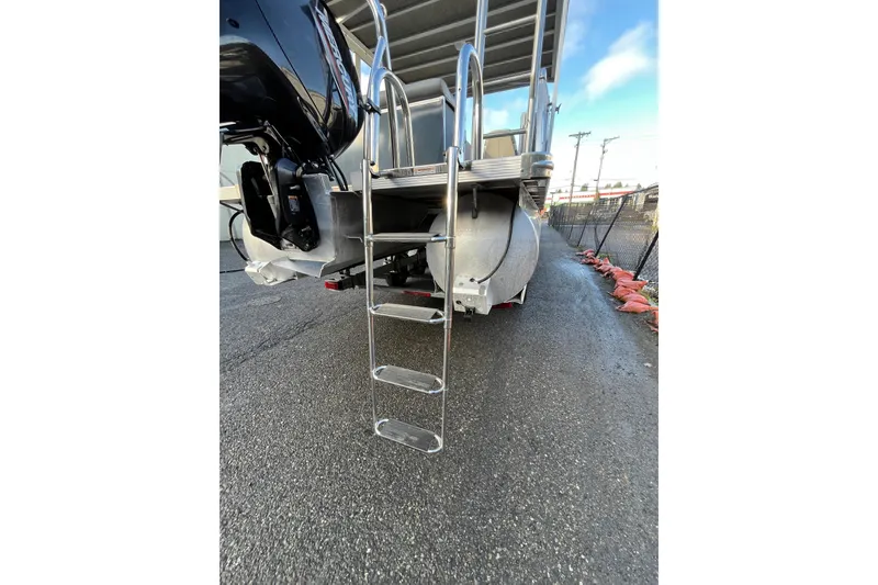 Slide: The Image of 2025 Tahoe Pontoon Cascade Cruise Funship rear view with ladder and motor. - 21