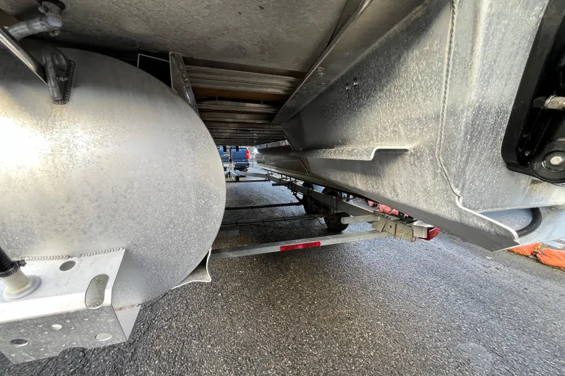 Slide: The Image of Underneath view of 2025 Tahoe Pontoon Cascade Cruise Funship on a trailer. - 22