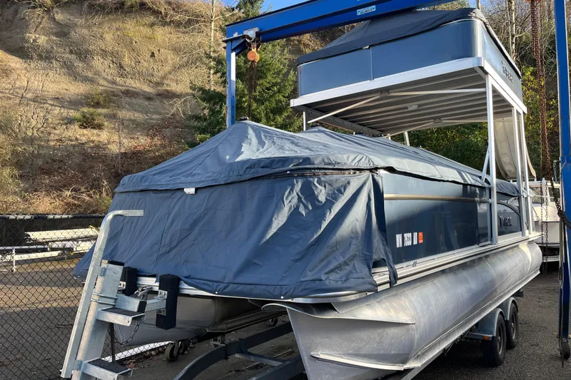 Slide: The Image of 2025 Tahoe Pontoon Cascade Cruise Funship on trailer, covered and parked outdoors. - 24