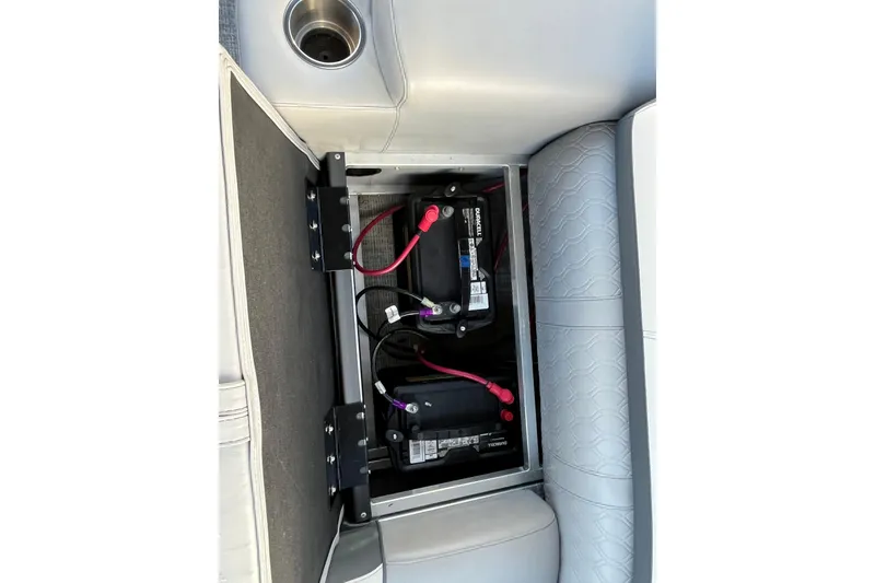 Slide: The Image of Battery compartment of 2025 Tahoe Pontoon Cascade Cruise Funship, featuring dual batteries and wiring. - 7