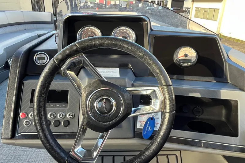 Slide: The Image of 2025 Tahoe Pontoon Cascade Cruise Funship dashboard with steering wheel and gauges. - 9