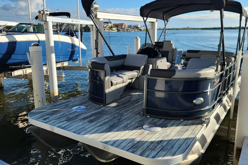 The Image of 2023 Veranda Fish VF25F2plus2 pontoon boat docked by the water. - 0