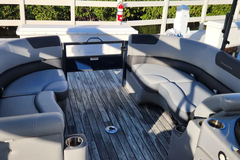 Slide: The Image of 2023 Veranda Fish VF25F2plus2 pontoon boat with spacious seating and wood-style flooring. - 11