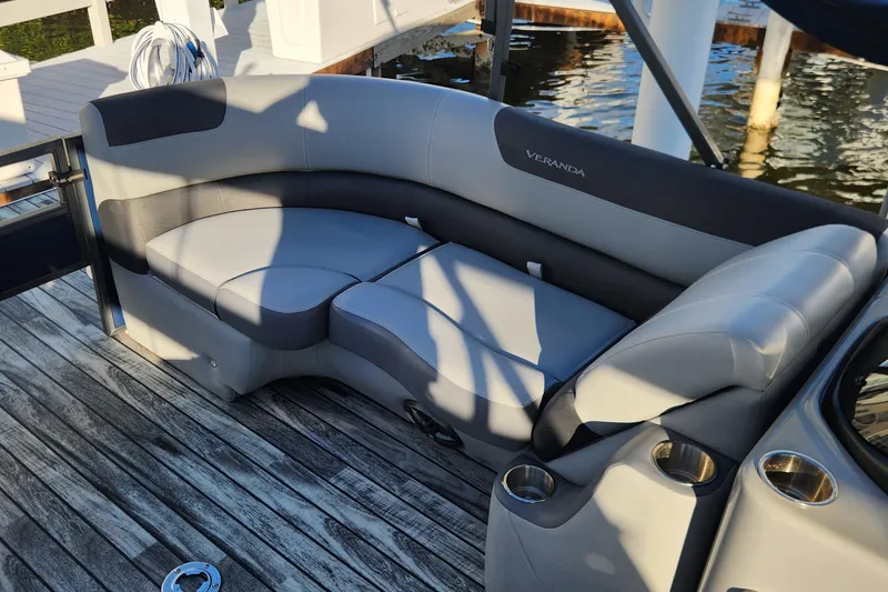Slide: The Image of 2023 Veranda Fish VF25F2plus2 boat seating with cup holders on a wooden deck. - 13