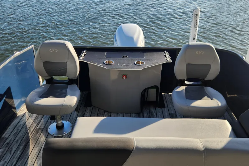 Slide: The Image of 2023 Veranda Fish VF25F2plus2 boat interior with seating and fishing station on water. - 15