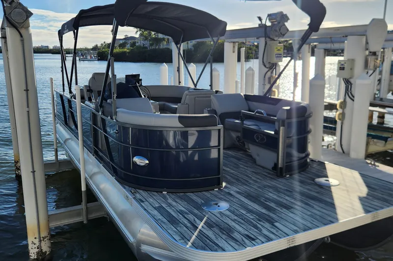 Slide: The Image of 2023 Veranda Fish VF25F2plus2 pontoon boat docked on a sunny day. - 3
