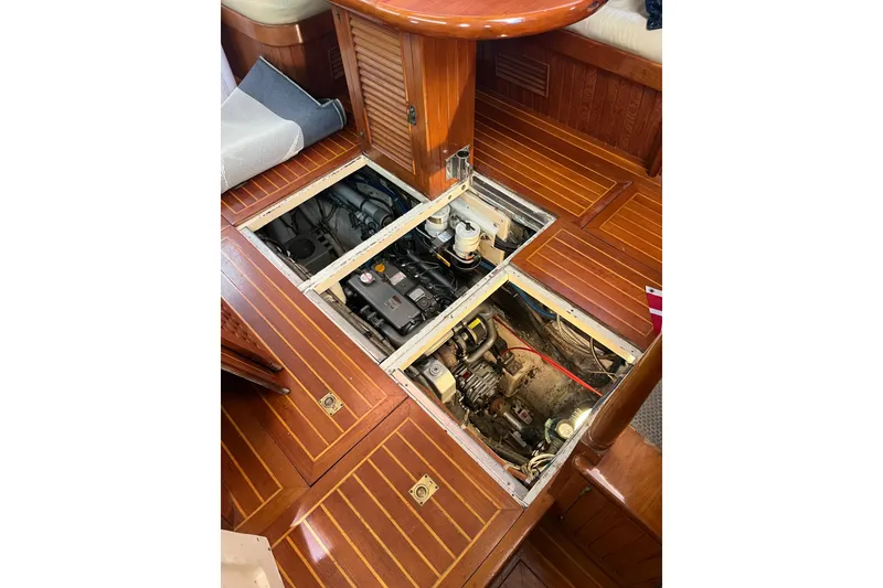 Slide: The Image of Interior view of 1986 Liberty 49 yacht, showcasing wooden stairs and helm station. - 19