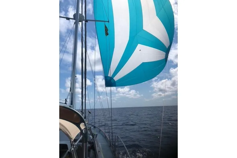Slide: The Image of 1986 Liberty 49 sailboat cockpit with wooden accents and steering wheel, docked at marina. - 20