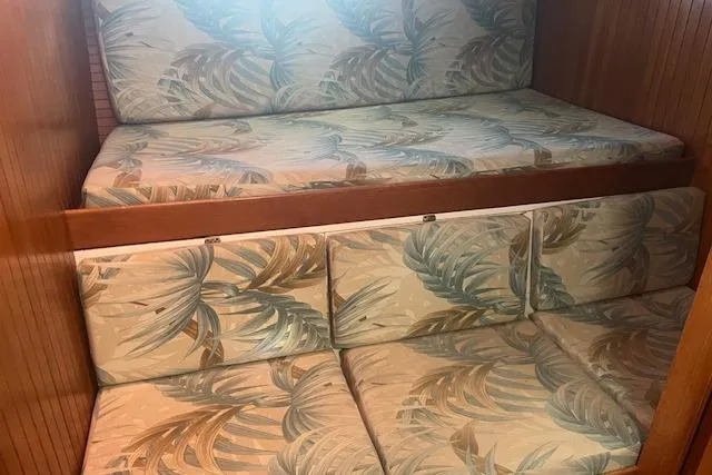 Slide: The Image of 1986 Liberty 49 sailboat deck with anchor chain and winch in marina. - 27