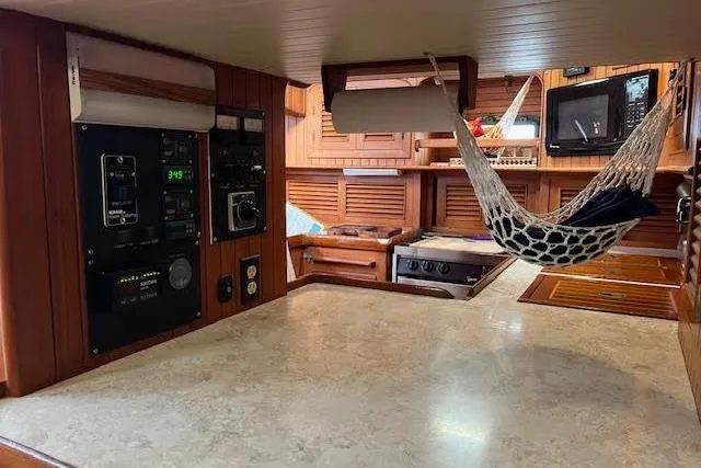 Slide: The Image of 1986 Liberty 49 yacht interior with wooden cabinetry and decorative elements. - 36
