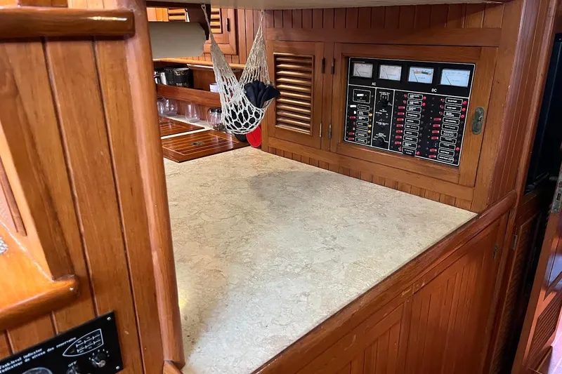 Slide: The Image of Wooden interior of 1986 Liberty 49 boat, featuring a door and visible toilet. - 40