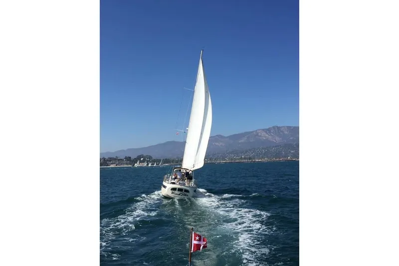 Slide: The Image of 1986 Liberty 49 yacht interior with hammock, wooden paneling, and fire extinguisher. - 48