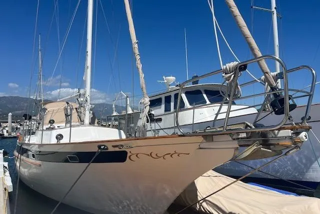 Slide: The Image of 1986 Liberty 49 sailboat docked at marina under clear blue sky. - 6