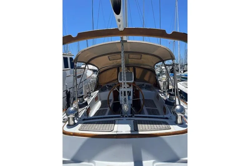 Slide: The Image of 1986 Liberty 49 sailboat docked in a marina with clear blue skies. - 8