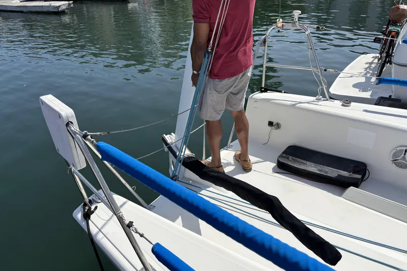 Slide: The Image of Man on Flying Tiger FT-10M sailboat, 2007 model, adjusting rigging at marina. - 10