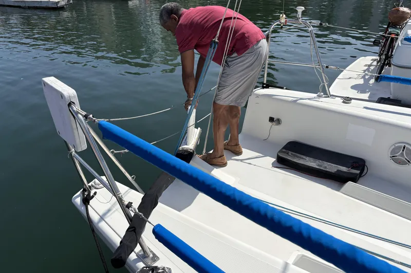 Slide: The Image of Man securing a 2007 Flying Tiger FT-10M sailboat at the dock. - 11