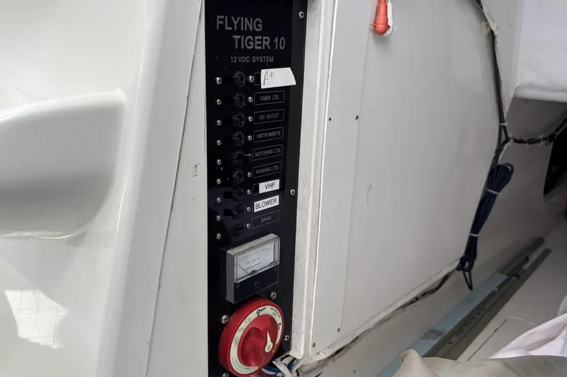 Slide: The Image of Control panel of a 2007 Flying Tiger FT-10M sailboat, featuring various switches and a gauge. - 34