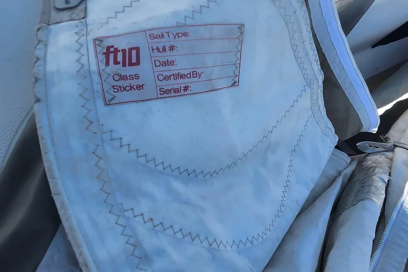 Slide: The Image of Close-up of a Flying Tiger FT-10M sail label, showing class sticker details. - 41