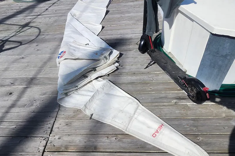Slide: The Image of Folded sail on wooden dock beside electric scooter, Flying Tiger FT-10M, 2007. - 48
