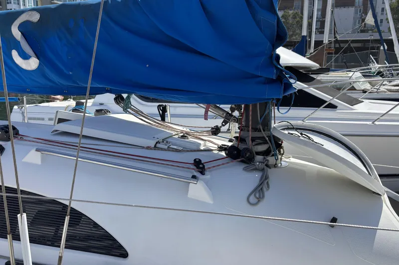 Slide: The Image of Sailboat with blue sail, Flying Tiger FT-10M, 2007 model, docked at marina. - 6
