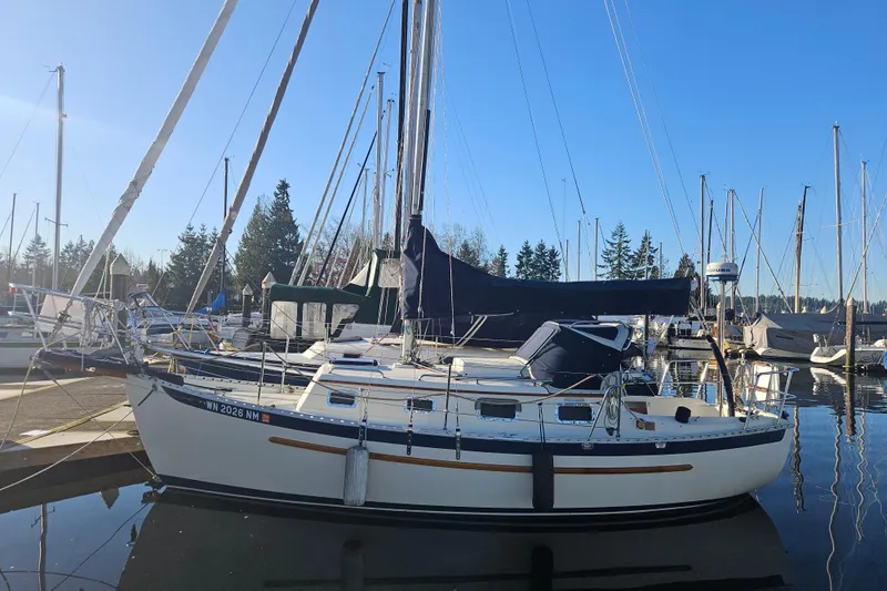 The Image of 2003 Pacific Seacraft Dana 24 sailboat docked in a marina under clear blue skies. - 0