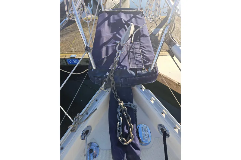 Slide: The Image of Bow of 2003 Pacific Seacraft Dana 24 sailboat with anchor chain and blue cover. - 11
