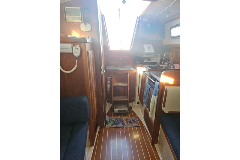 Slide: The Image of Interior of 2003 Pacific Seacraft Dana 24 sailboat, featuring cozy cabin and wooden finishes. - 14