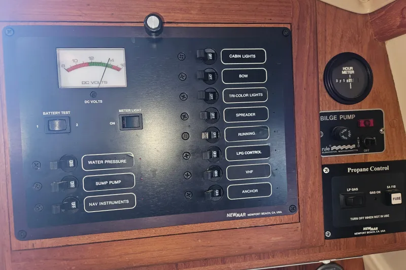 Slide: The Image of Control panel of a 2003 Pacific Seacraft Dana 24 sailboat with various switches and gauges. - 23