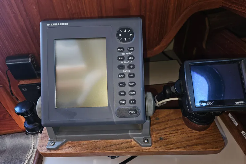 Slide: The Image of Navigation equipment on a 2003 Pacific Seacraft Dana 24 sailboat, featuring Furuno and Garmin displays. - 27
