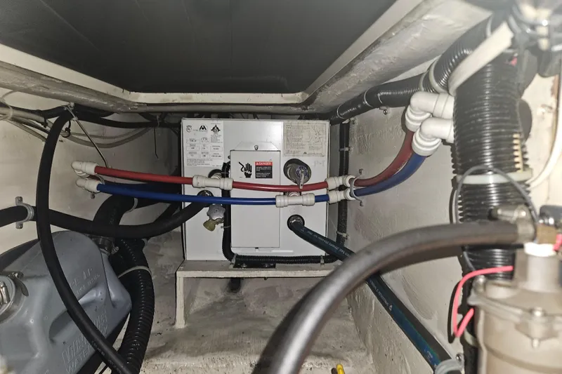 Slide: The Image of Engine compartment of a 2003 Pacific Seacraft Dana 24 sailboat, showing wiring and plumbing. - 30