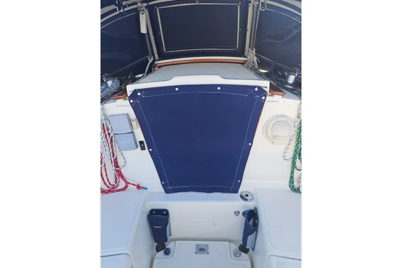Slide: The Image of Interior view of a 2003 Pacific Seacraft Dana 24 sailboat cockpit with blue cover. - 5