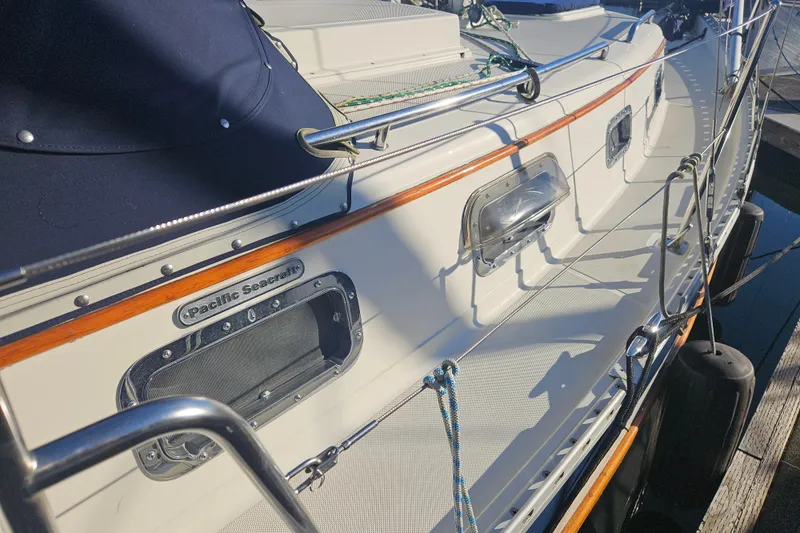 Slide: The Image of 2003 Pacific Seacraft Dana 24 sailboat deck with polished fittings and sleek design. - 7